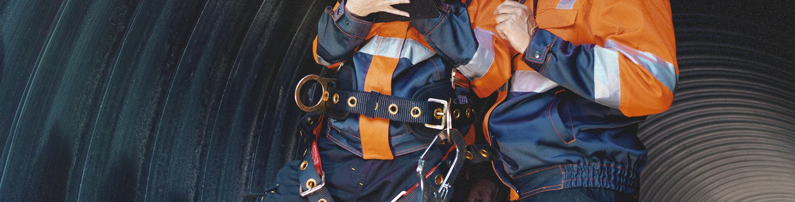 Workers in protective clothing and harness equipment in YOKE’s company banner