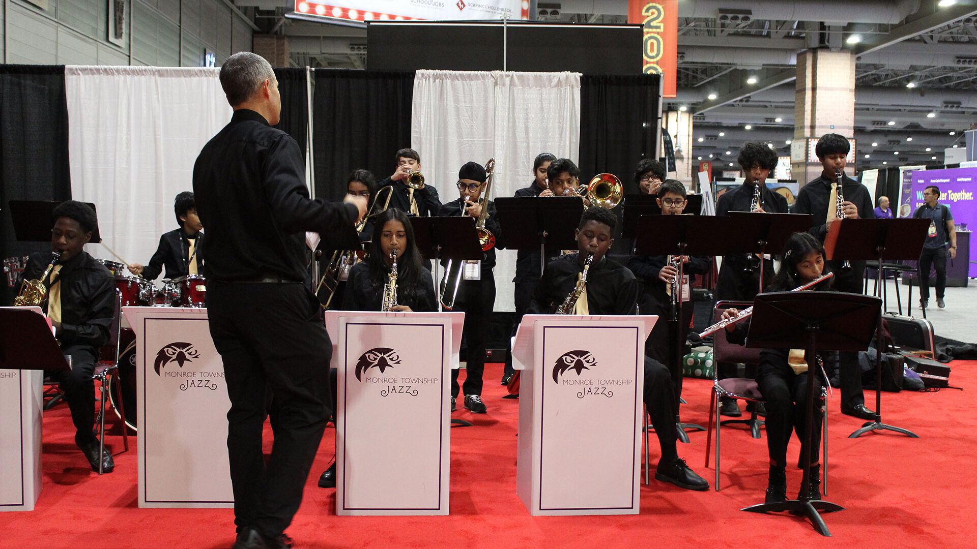 Student jazz ensemble performing on the Workshop 2025 exhibit floor.